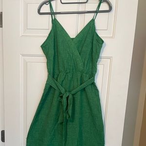 Green jumpsuit with open back design